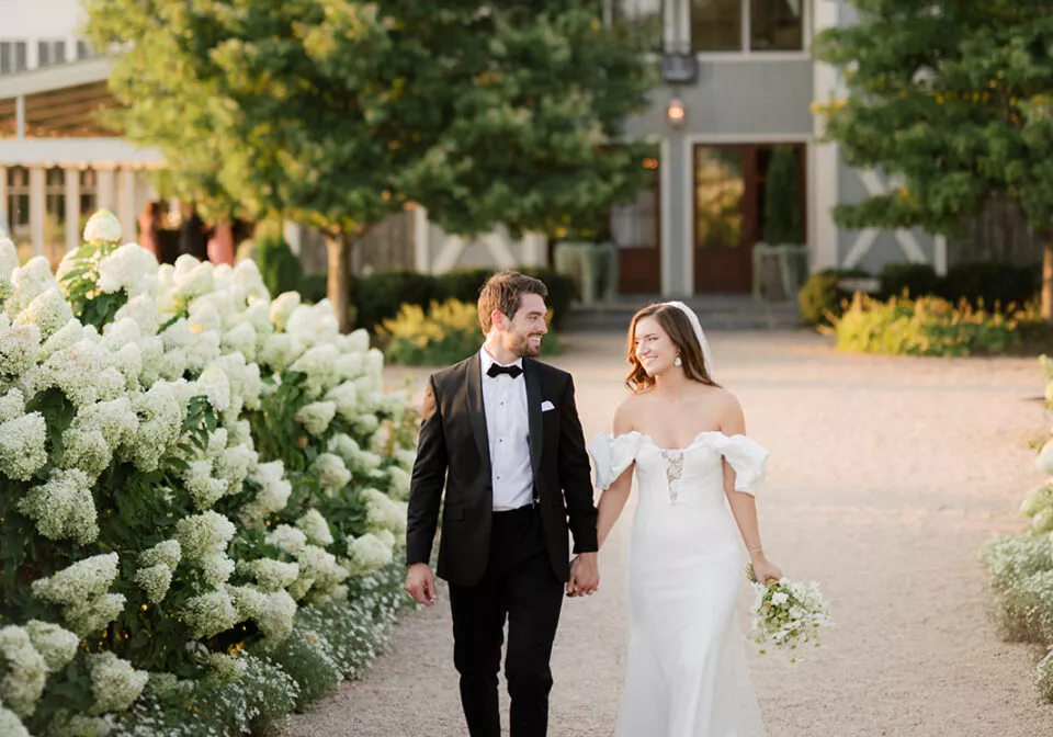 A bride and groom walking hand in hand at Pippin Hill