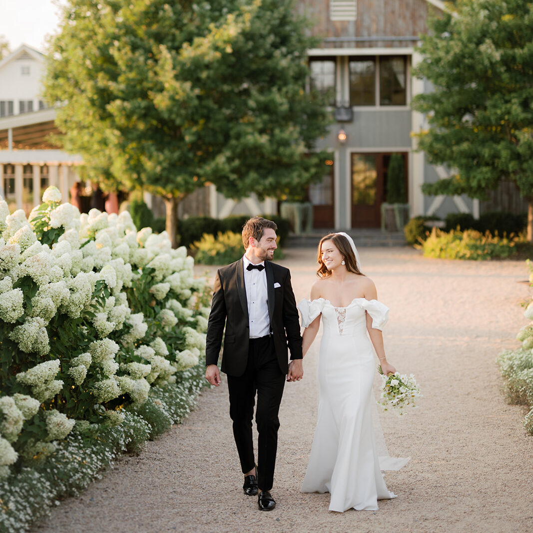 A bride and groom walking hand in hand at Pippin Hill